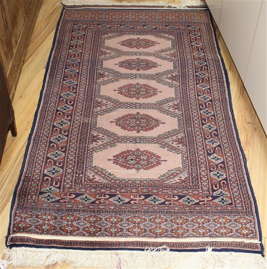 A Bokhara peach ground rug, 175 x 93cm